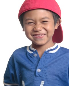 Cute happy boy in red baseball cap